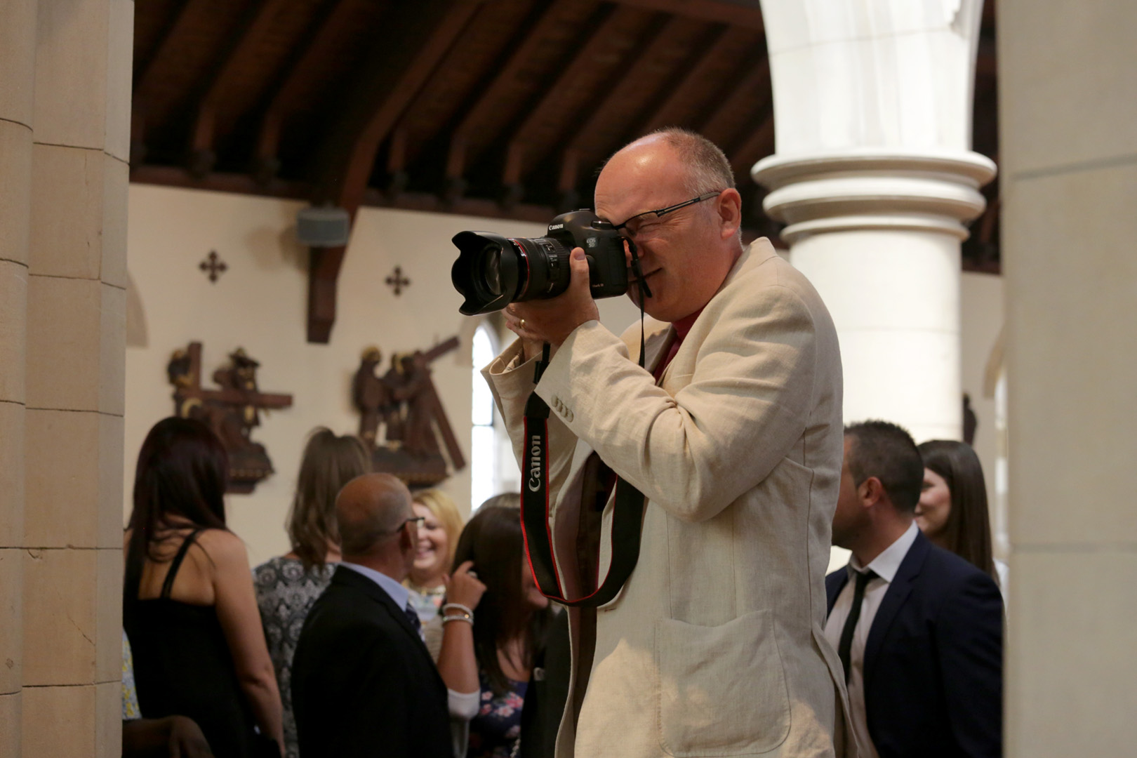 Tim Durham photographing a wedding at Saint Lawrence's Church Eastcote. Tim works at Pinner Wedding Photography and is a photographer in Harrow and a photographer in Ruislip