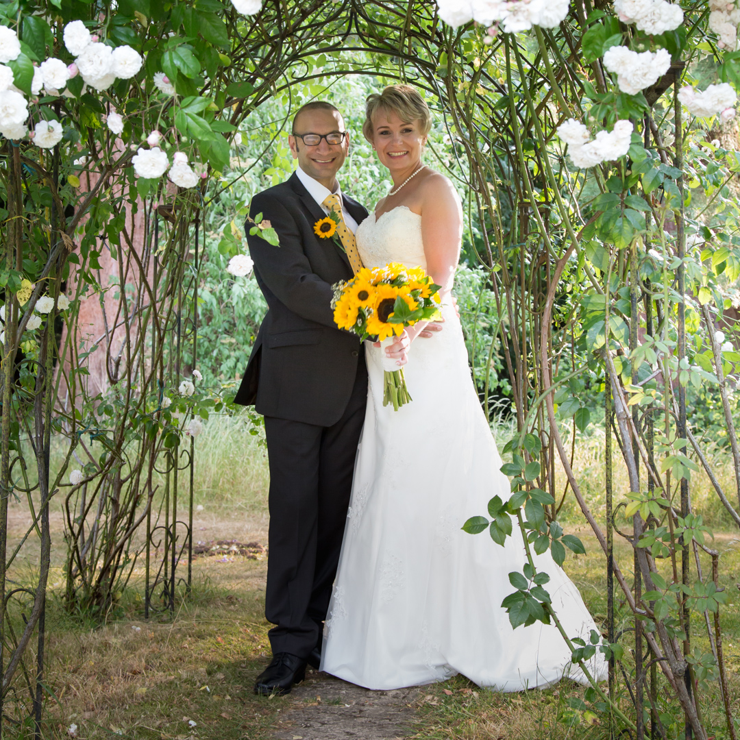 The Bride and Groom in the Rose Garden at the Grim's Dyke Hotel Harrow London 0063