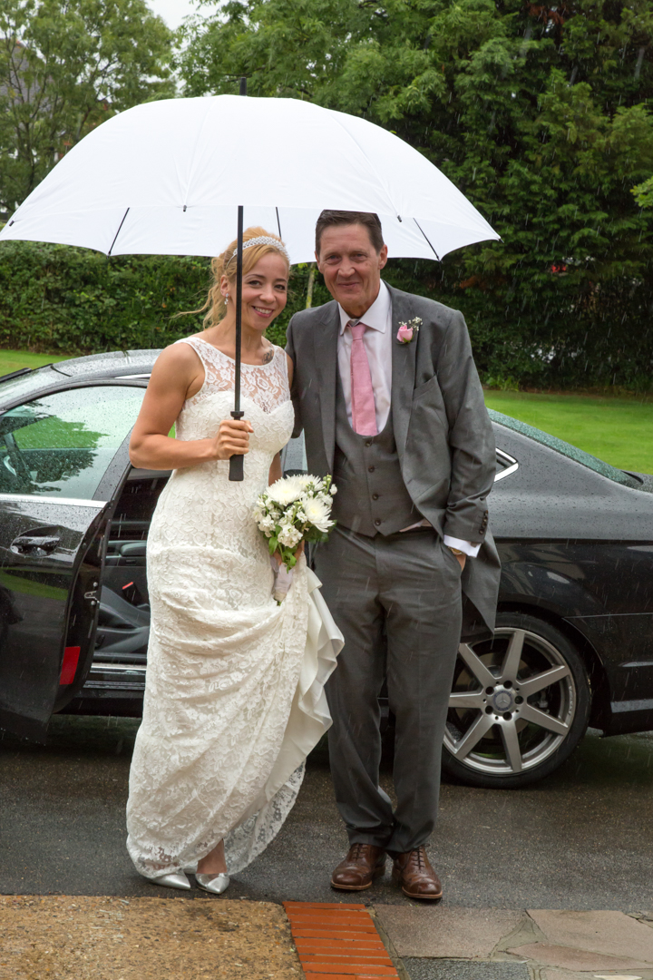 Cavendish Eastcote - Bride & Groom arriving in the rain photographed by Tim Durham of Pinner wedding photography